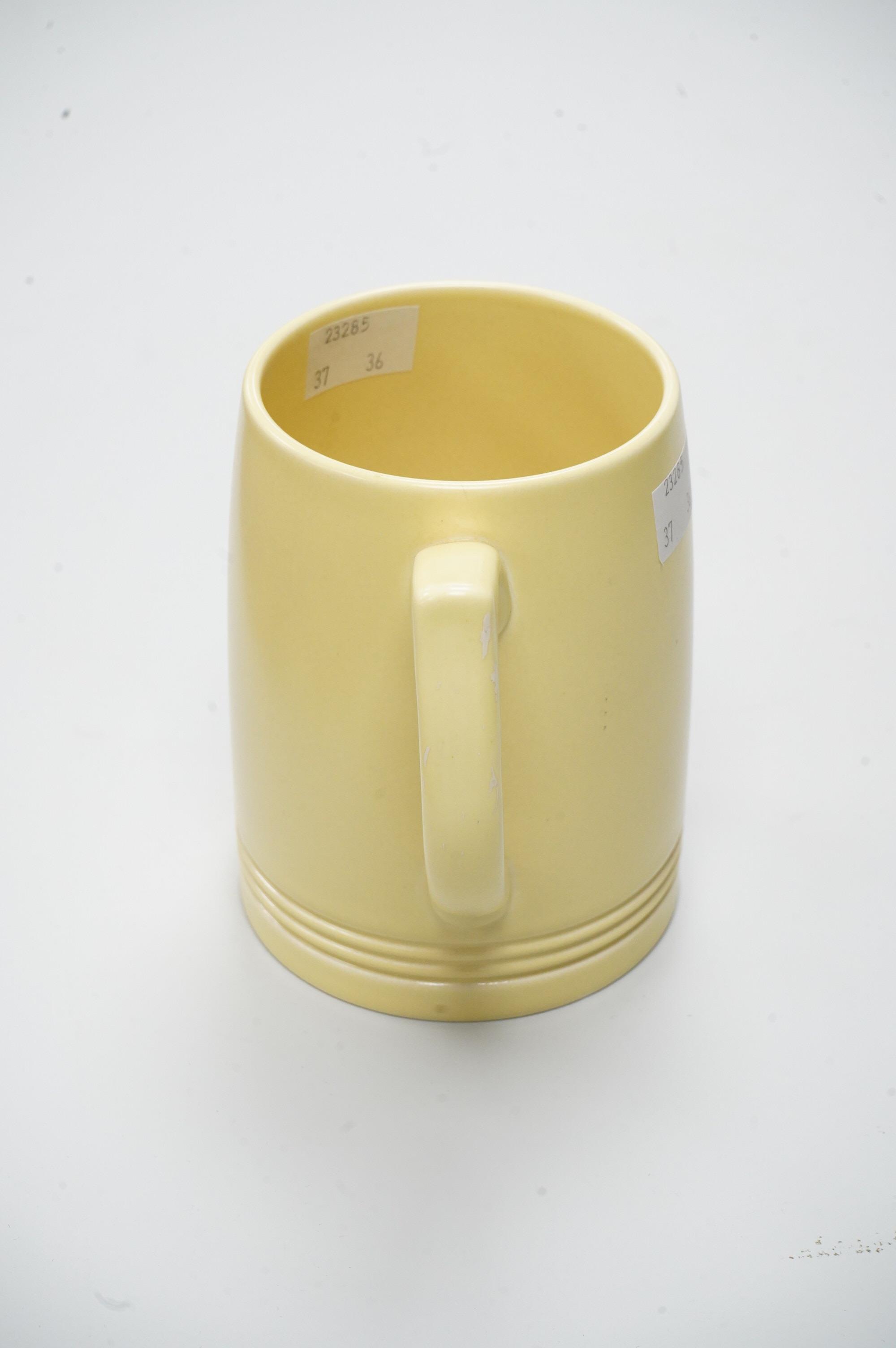 A Keith Murray Wedgwood mug in matt straw, 12cm